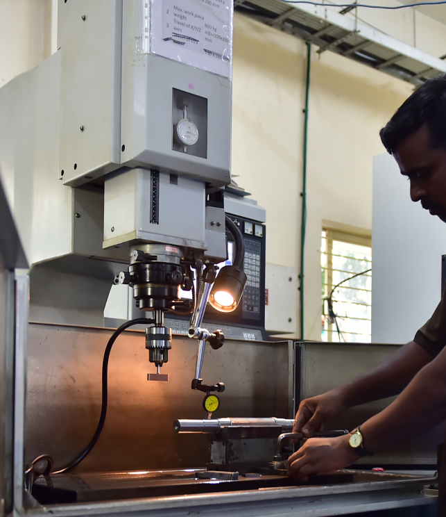 Technician operating a precision machine at ELCIA Tech Hub