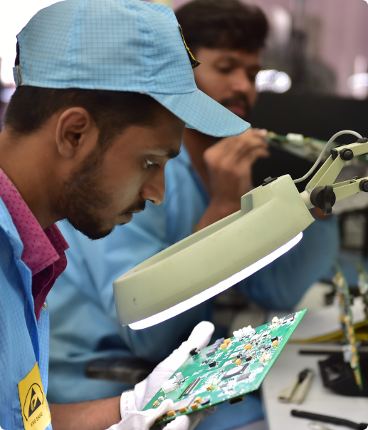 Technician inspecting a circuit board at ELCIA Tech Hub